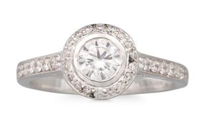 Lot 136 - A DIAMOND HALO CLUSTER RING, set with...