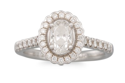 Lot 232 - A DIAMOND HALO CLUSTER RING, the brilliant cut...