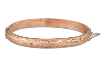 Lot 52 - A 9CT GOLD ENGRAVED HINGED BANGLE, 9.9 g.