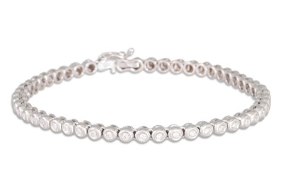 Lot 151 - A DIAMOND LINE BRACELET, the brilliant cut...