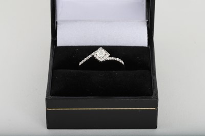 Lot 86 - A DIAMOND CLUSTER RING, set with princess and...