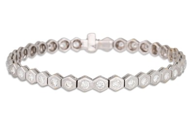 Lot 201 - A DIAMOND LINE BRACELET, the brilliant cut...