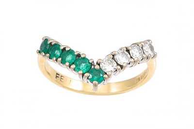 Lot 60 - A DIAMOND AND EMERALD WISH BONE RING, mounted...