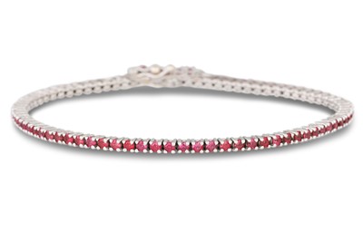 Lot 261 - A RUBY LINE BRACELET, circular stones mounted...