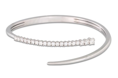 Lot 58 - A DIAMOND BANGLE, of cross-over design, in...