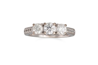 Lot 235 - A DIAMOND THREE STONE RING, set with brilliant...