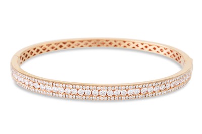 Lot 264 - A TRIPLE ROW DIAMOND SET HINGED BANGLE,...