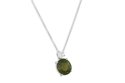 Lot 134 - A TOURMALINE AND DIAMOND PENDANT, the oval...