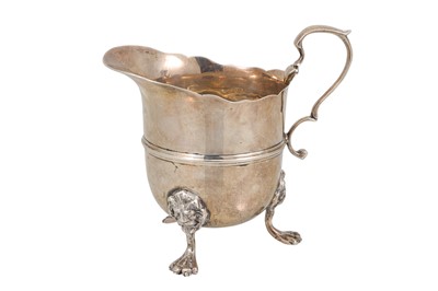 Lot 537 - AN EDWARDIAN SILVER CREAM JUG OF HELMET SHAPED...