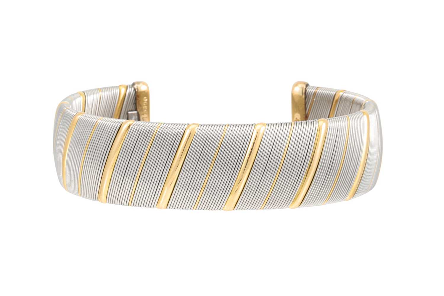 Lot 324 - A VINTAGE CARTIER 'OR ET ACIER' BANGLE, in...