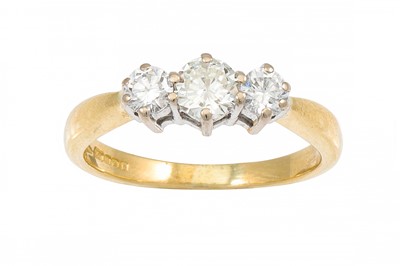 Lot 449 - A THREE STONE DIAMOND RING, the brilliant cut...