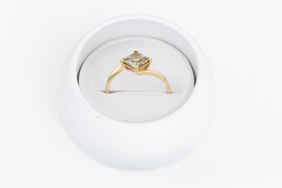 Lot 22 - A GEMSTONE DRESS RING, mounted in 9ct yellow...