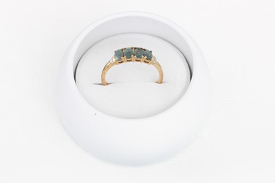 Lot 24 - AN ALEXANDRITE FOUR STONE RING, mounted in 9ct...