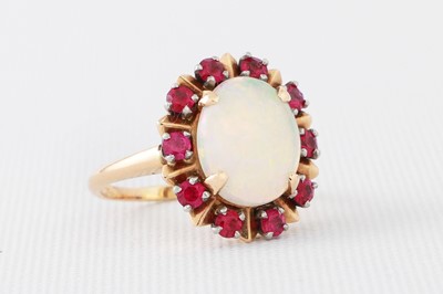 Lot 106 - AN OPAL AND SYNTHETIC RED STONE CLUSTER RING,...