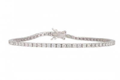 Lot 85 - A DIAMOND LINE BRACELET, the brilliant cut...