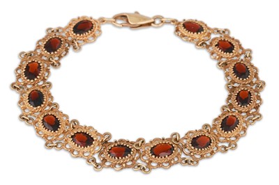 Lot 232 - A GOLD AND GARNET BRACELET, of open work form,...