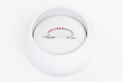 Lot 78 - A DIAMOND AND RUBY THREE QUARTER ETERNITY RING,...