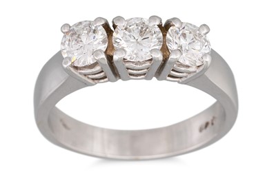 Lot 195 - A THREE STONE DIAMOND RING, the brilliant cut...