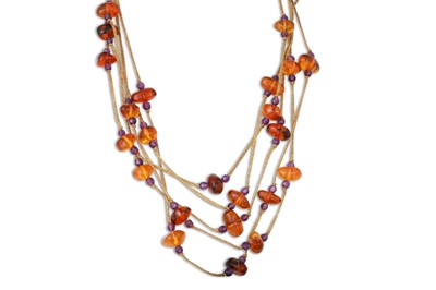 Lot 152 - AN AMBER NECKLACE, on a cord with gold fittings