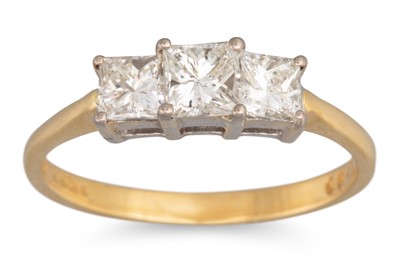 Lot 28 - A DIAMOND THREE STONE RING, the princess cut...