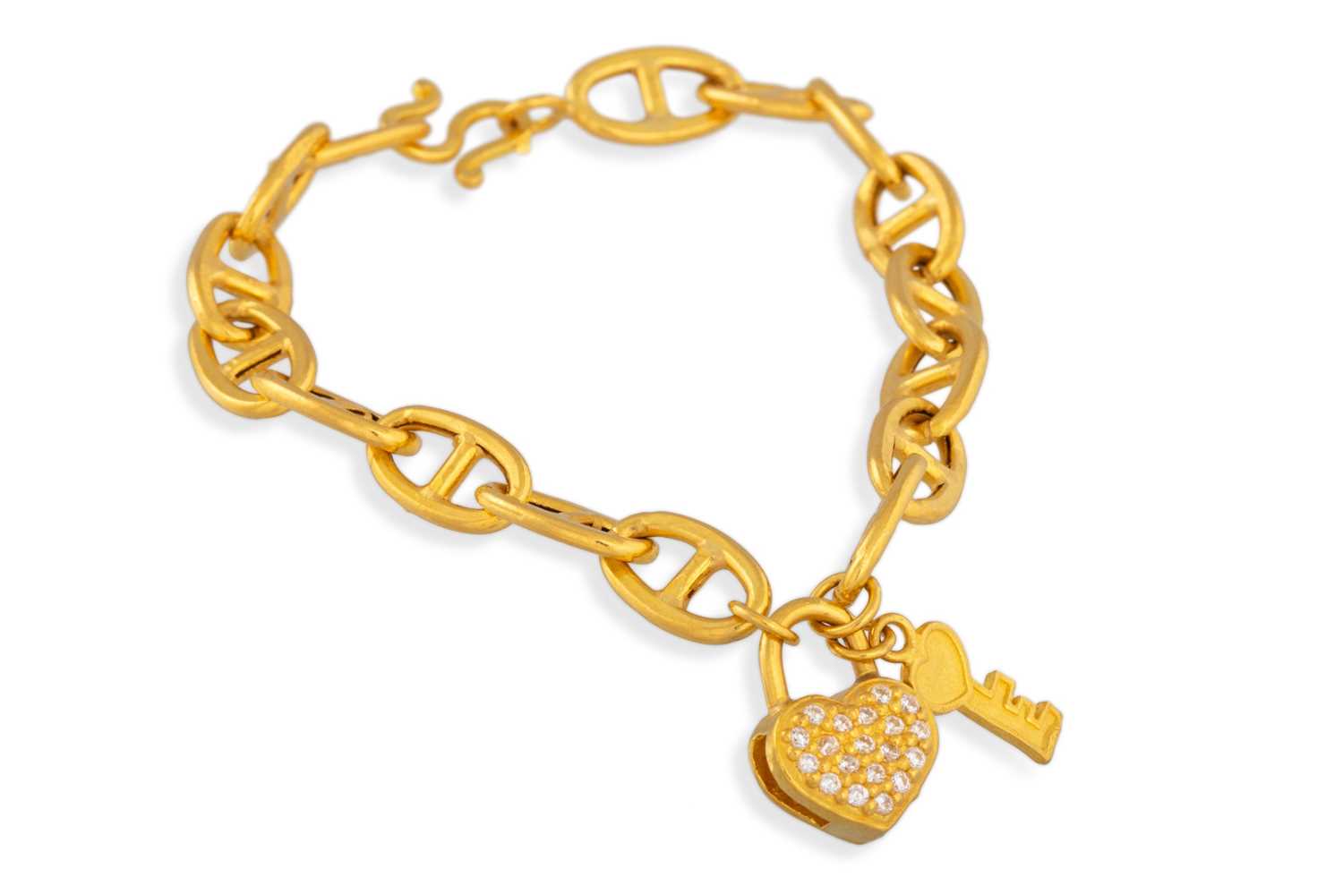 Lot 53 - A 22CT GOLD BRACELET, suspending charms, 8 g