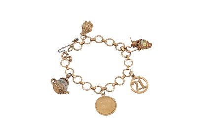 Lot 69 - A GOLD CHARM BRACELET, five charms attached,...