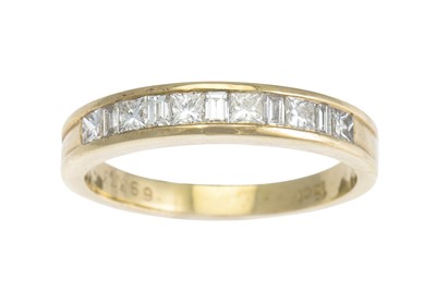 Lot 195 - A DIAMOND HALF ETERNITY RING, the channel set...