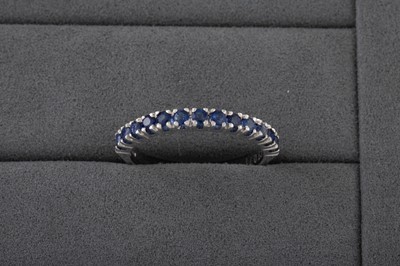 Lot 147 - A SAPPHIRE HALF ETERNITY RING, mounted in 18ct...