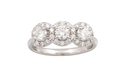 Lot 282 - A DIAMOND TRIPLE CLUSTER RING, the brilliant...