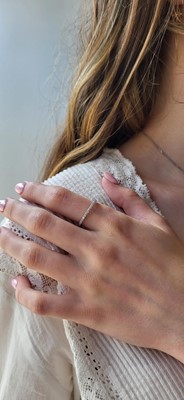 A DIAMOND HALF ETERNITY RING, the brilliant...