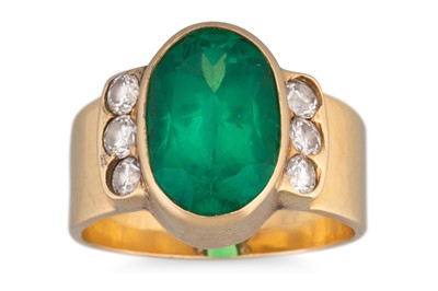 Lot 235 - AN EMERALD AND DIAMOND RING, the oval emerald...