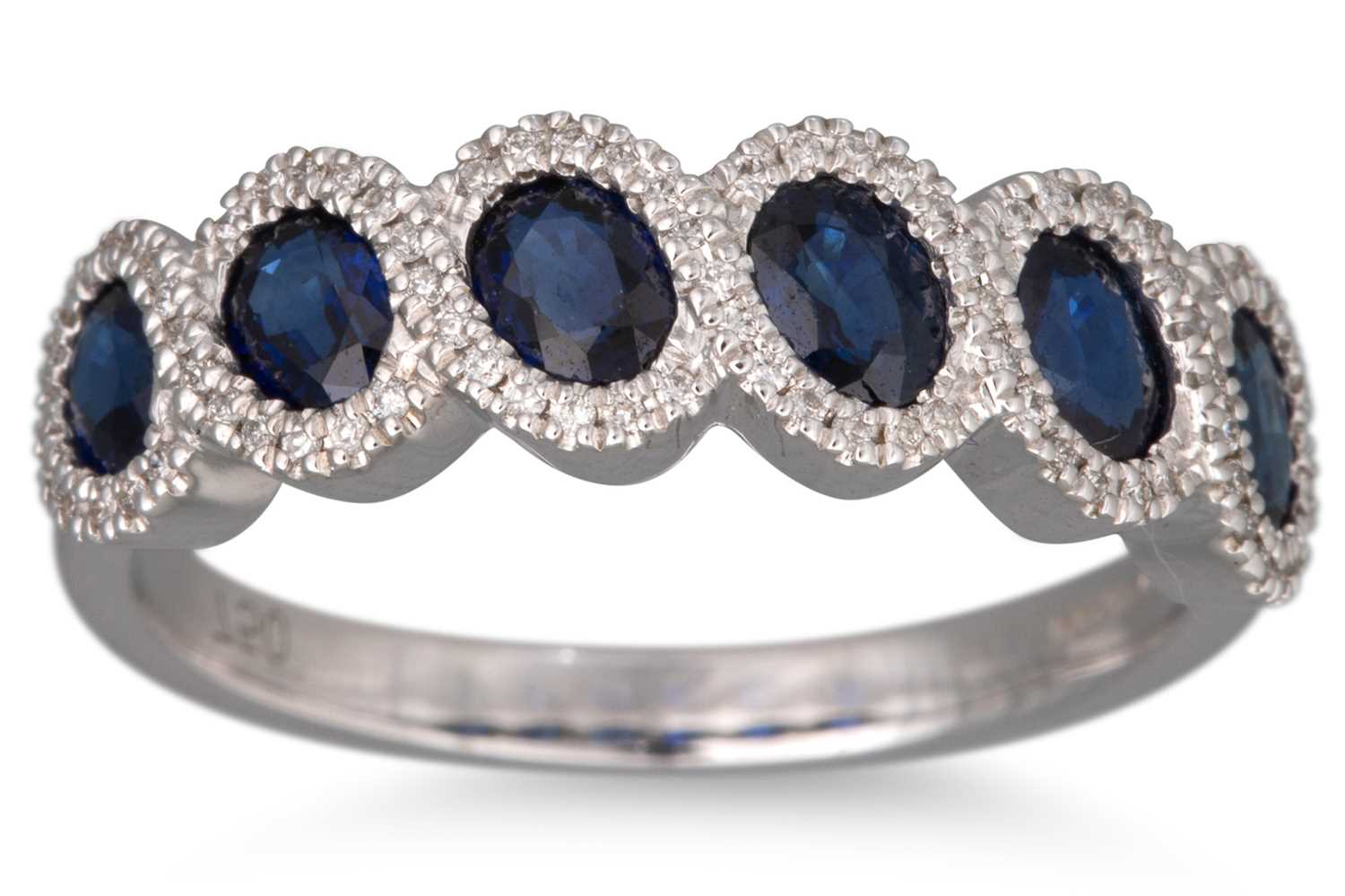 Lot 58 - A DIAMOND AND SAPPHIRE RING, the six oval...