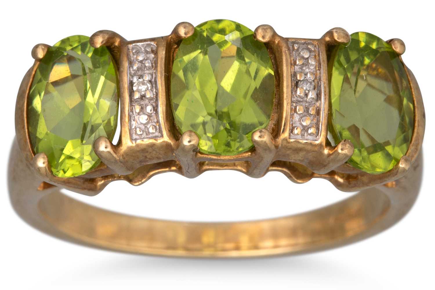 Lot 62 - A THREE STONE PERIDOT AND DIAMOND RING, the...