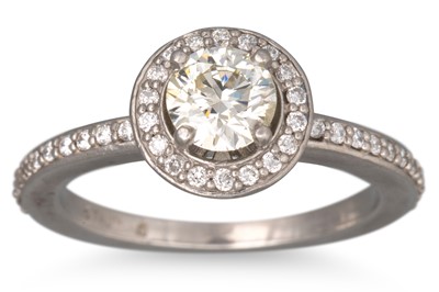 Lot 92 - A DIAMOND HALO CLUSTER RING, the round cut...