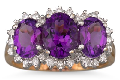 Lot 106 - A DIAMOND AND AMETHYST CLUSTER RING, the three...