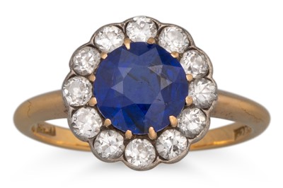 Lot 165 - A DIAMOND AND SAPPHIRE CLUSTER RING, of...