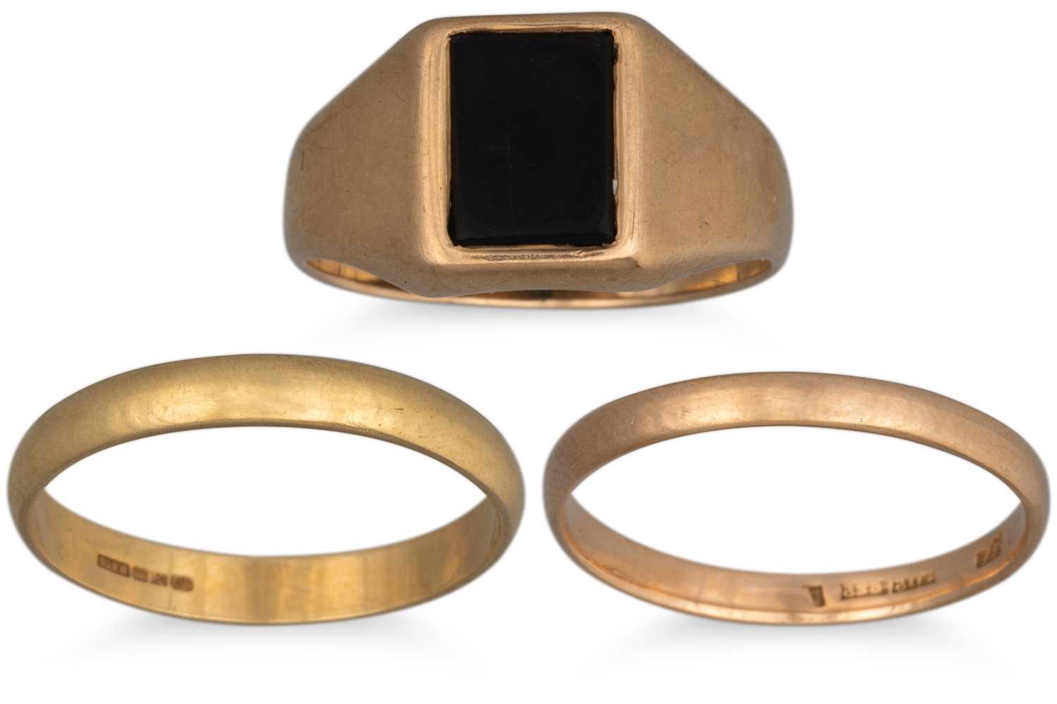 Lot 14 - THREE GOLD RINGS, one 9ct with onyx, one 18ct...
