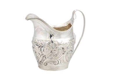 Lot 524 - A GEORGE III SILVER EMBOSSED MILK JUG, (108...