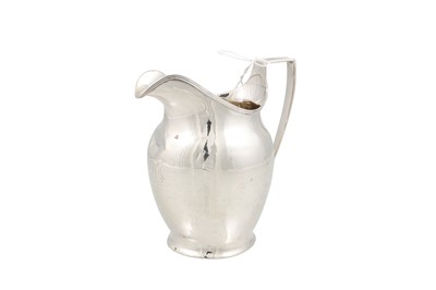 Lot 525 - A GEORGE III SILVER PLAIN MILK JUG, with...