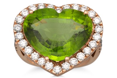 Lot 137 - A PERIDOT AND DIAMOND RING, the heart shaped...
