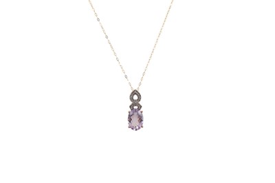 Lot 35 - A DIAMOND AND AMETHYST PENDANT, pave set...