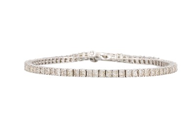 Lot 43 - A DIAMOND LINE BRACELET, the princess cut...