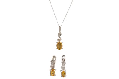 Lot 48 - A  DIAMOND AND TOPAZ PENDANT, mounted in white...