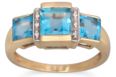 Lot 63 - A BLUE TOPAZ RING, the three square topaz...