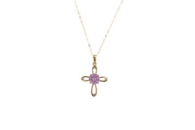 Lot 129 - A DIAMOND AND AMETHYST CROSS PENDANT, the...