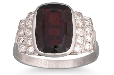Lot 242 - A GARNET AND DIAMOND RING, the cushion cut...