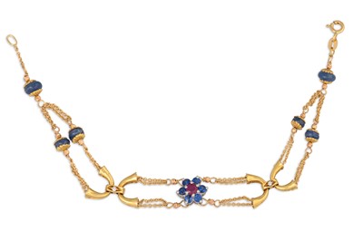 Lot 247 - A RUBY AND SAPPHIRE BRACELET, the central...