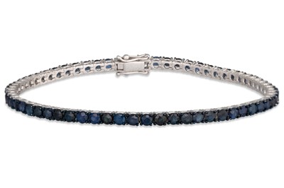 Lot 211 - A SAPPHIRE LINE BRACELET, the circular stones...