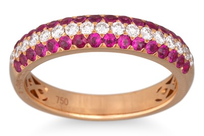 Lot 213 - A THREE ROWED PAVÉ SET RUBY AND DIAMOND RING,...