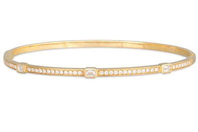 Lot 230 - A DIAMOND SET BANGLE, set with emerald cut and...